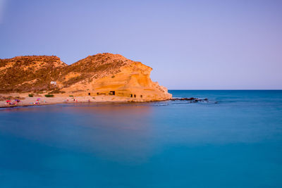 Scenic view of sea against clear blue sky