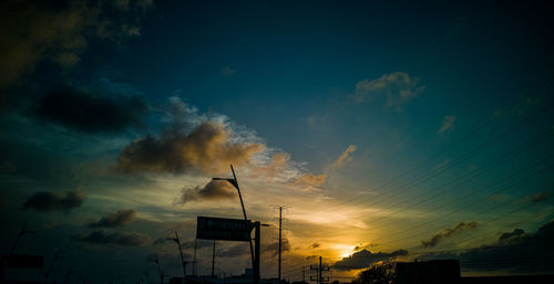 Low angle view of silhouette building against sky during sunset