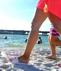 Rear view of woman standing on beach