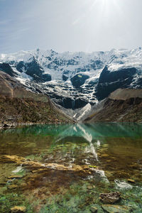 Laguna humantay with snow covered mountains in the background