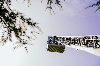 Low angle view of flags hanging against sky