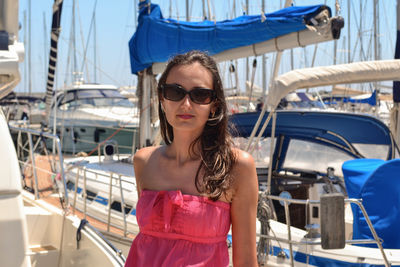 Portrait of young woman wearing sunglasses while standing in city