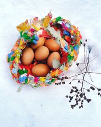 High angle view of eggs in rag basket on snow