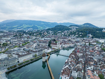 High angle view of townscape by sea against sky