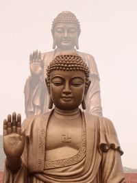 Statue of buddha against building