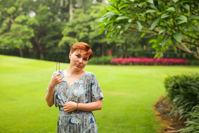 Full length of woman standing on grass