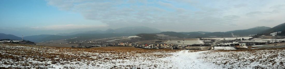 Scenic view of mountains against cloudy sky