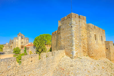 Old ruin building against blue sky