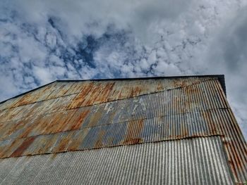 Low angle view of building against cloudy sky