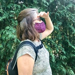 Midsection of woman wearing mask outdoors