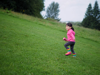 Full length of cute girl on field