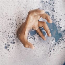 Close-up of hand in bathtub