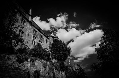 Low angle view of abandoned building against sky