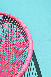 Summer armchair against a blue wall. home decor in detail. minimalist aesthetic