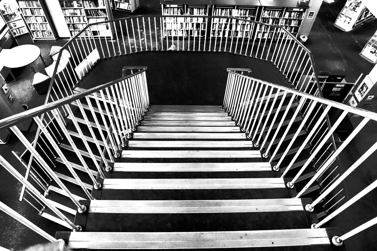 black and white, staircase, steps and staircases, monochrome, monochrome photography, railing, architecture, high angle view, indoors, no people, black, built structure, pattern, stairs, the way forward