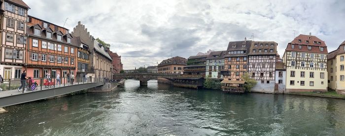 Canal passing through buildings in city