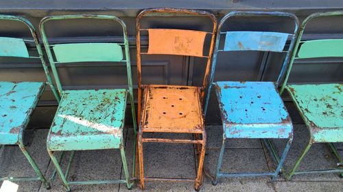 Abandoned chairs in row