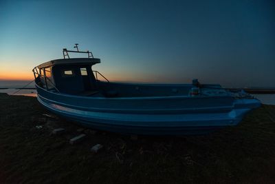 Boat moored on sea against clear sky