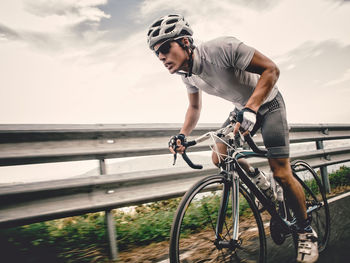 Man riding bicycle on railing