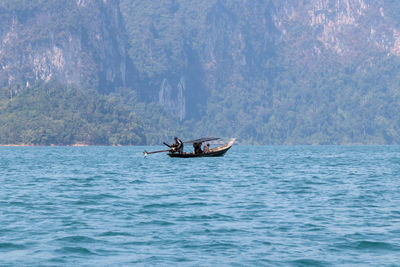 People sailing on boat in sea