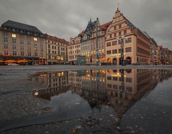 Reflection of buildings in puddle