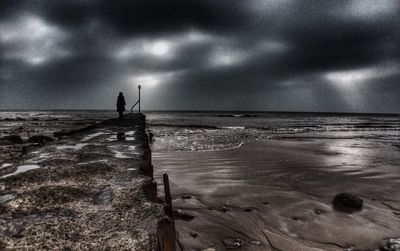 Scenic view of sea against cloudy sky