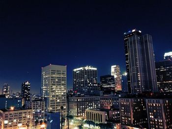 View of skyscrapers lit up at night