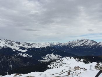 Scenic view of snow covered mountains against sky