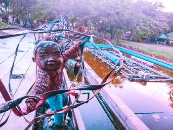 Reflection of man sculpture on water