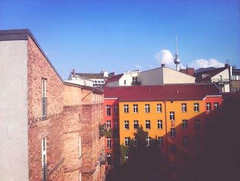 Buildings in city against blue sky