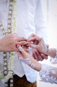 Midsection of couple during ring ceremony