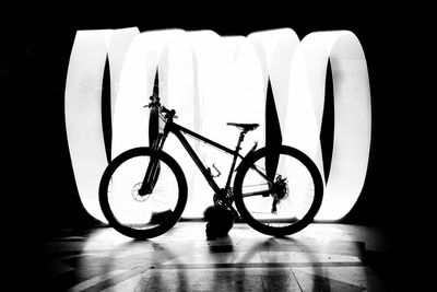 Close-up of bicycle parked against black background
