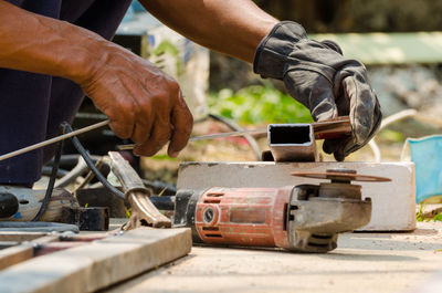 Low section of man working on chain