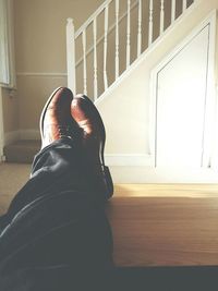 Low section of man relaxing on floor at home