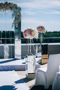 Flower vase on table against white wall