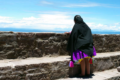 Young indian in taquile, with its pompoms which help to determine if she is married or not 