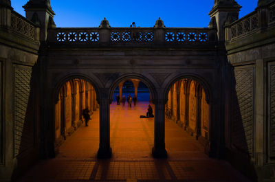 Man walking in illuminated historical building