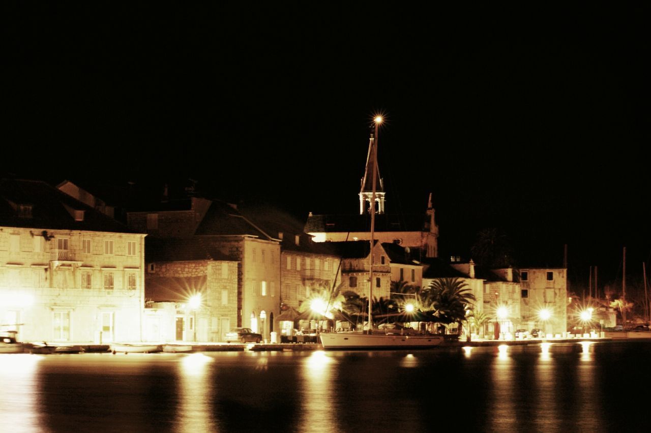 illuminated, night, architecture, built structure, building exterior, waterfront, water, clear sky, river, reflection, copy space, city, religion, outdoors, transportation, travel destinations, sky, no people, place of worship, famous place