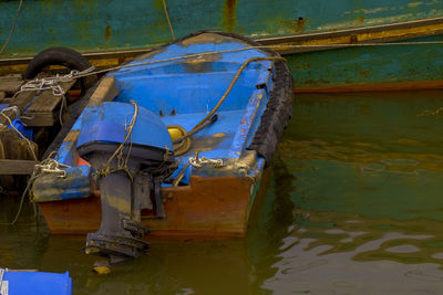 Abandoned boat moored in lake