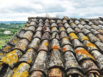 Low angle view of roof tiles against sky