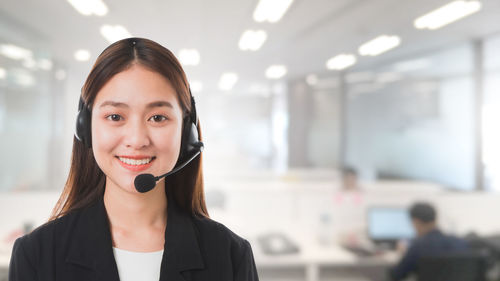 Portrait of a smiling young woman using mobile phone