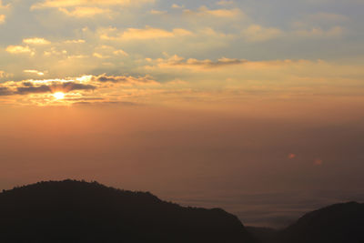 Scenic view of silhouette mountains against sky during sunset