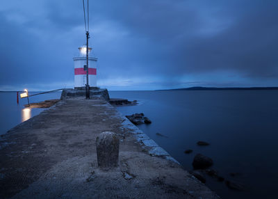 Lighthouse under dark clouds in the harbour of lidköping