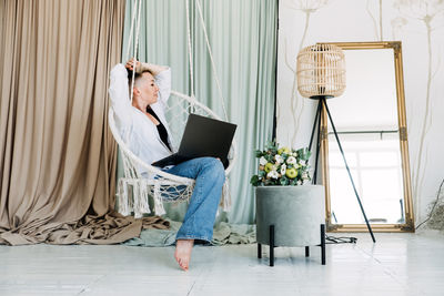 Hipster woman blogger working with laptop in studio. modern girl creator with laptop