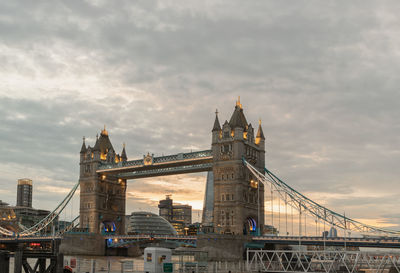 View of bridge over river against cloudy sky