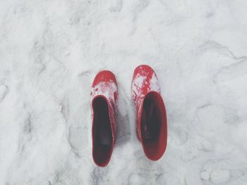 High angle view of red shoes on snow