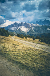 Scenic view of field and mountains against sky