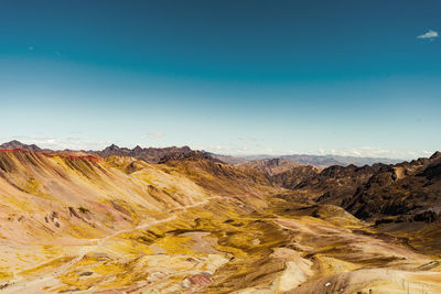 Scenic view of mountains against clear blue sky