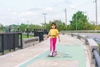 Portrait of woman walking on road