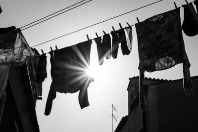 Low angle view of clothes drying on clothesline against building